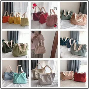 Detailed grid of minimalist canvas drawstring tote bags in assorted vibrant candy colors