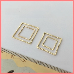 Detailed macro view of 14K gold-plated copper square jump rings for DIY jewelry making