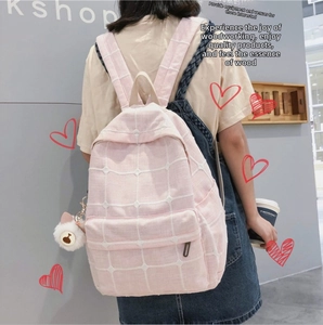Pink checkered backpack with cute cat ear plush ball charm detail on side pocket