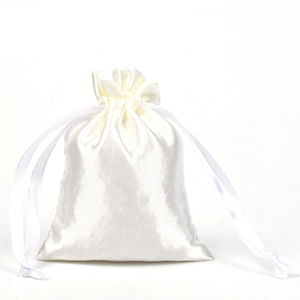 Detail of white satin drawstring pouch showing smooth glossy texture and premium silk-like fabric