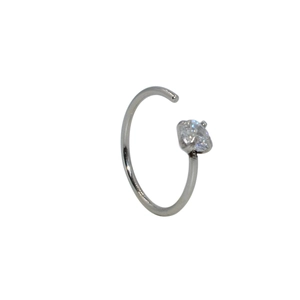 Close-up of silver stainless steel nose ring with a clear sparkling zircon stone