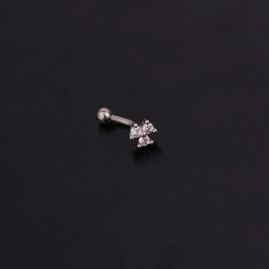 Detail of silver stainless steel curved barbell featuring a zircon flower stud design
