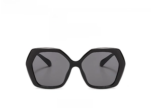 Front view of oversized geometric sunglasses with glossy black frames and grey lenses