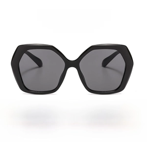 Detail shot of black oversized polygonal sunglasses with UV protection lenses