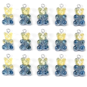 Macro view of fifteen resin gummy bear pendants with yellow-blue gradient and glitter