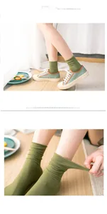 Detail of green ribbed cotton socks showing stretchability and breathable texture