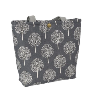 Gray linen lunch bag with white tree pattern and golden metal buckle closure