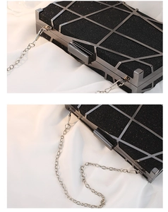 Detail of black sequined evening clutch with dark metal frame and thin chain strap