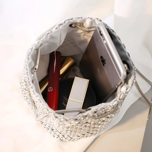 Sparkling silver rhinestone bucket bag with drawstring closure and metal chain strap