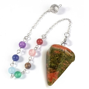 Macro view of Unakite stone pendulum pendant with colorful seven chakra beads and metal ball