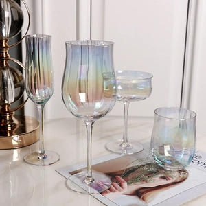 Rainbow crystal glass tulip cocktail and juice cups set on elegant marble surface