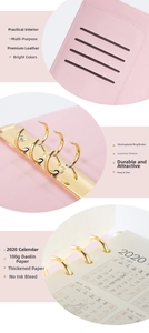 Detail of pink leather A5 binder with gold metal rings and multifunctional card slots