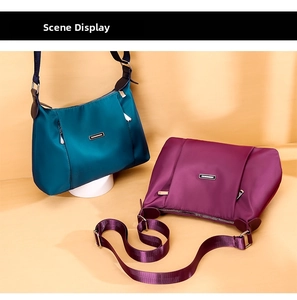 Detailed view of durable nylon crossbody bags in teal and purple with adjustable straps