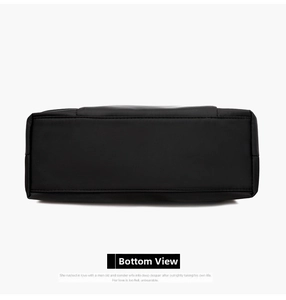 Detailed bottom view of the black Oxford cloth crossbody bag with reinforced stitching