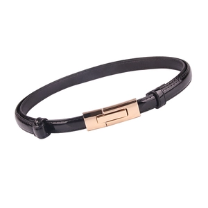 Glossy black patent leather belt for women featuring a minimalist gold buckle on white background