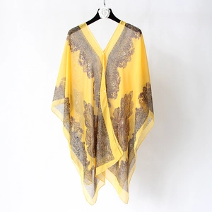 Detailed view of sheer chiffon shawl with paisley print and pearl button