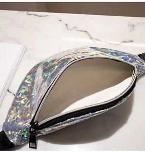 Detail of the holographic waist bag showing silver interior lining and zipper closure