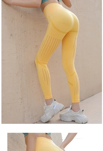 Detail of high-waisted yellow yoga pants with seamless breathable mesh and butt lift effect
