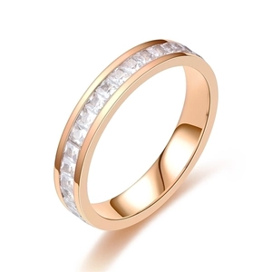 Macro shot of rose gold ring featuring a full circle of square-cut clear cubic zirconia stones