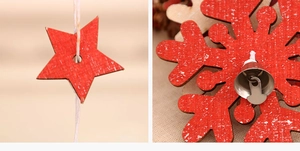 Close-up of red wooden star and snowflake ornaments with small metal bells for Christmas