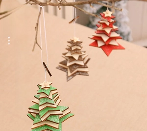 Three-piece wooden star Christmas tree ornaments hanging on branches with rustic beads