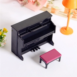 Detailed macro view of a miniature black piano and pink stool dollhouse furniture set