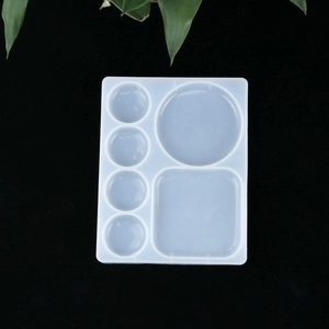Detail of translucent silicone resin mold with multiple circular and square cavities
