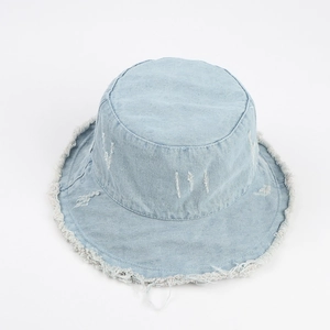 Detail of light blue denim bucket hat featuring vintage distressed frayed edges and washed finish