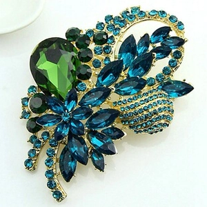 Macro shot of vintage insect brooch with gold plating and blue waterdrop gemstones