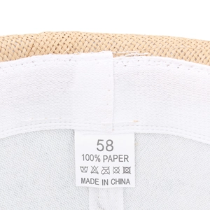 Close-up of interior label and straw texture of a men's breathable sun fedora hat.