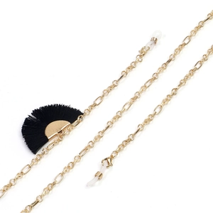 Close-up of golden metal eyeglass chain with black fan-shaped tassel and silicone loops