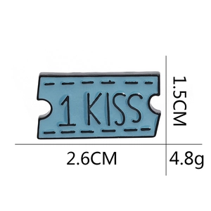 Detailed view of blue ticket-shaped enamel brooch with 1 KISS text and size measurements