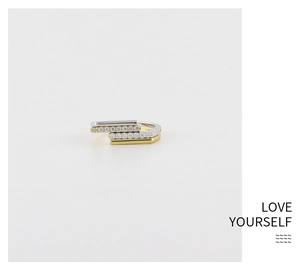 Macro detail of minimalist 925 silver layered ring with inlaid zircons and gold plating