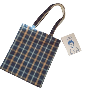Minimalist plaid cotton tote bag with blue and orange grid pattern and shoulder straps