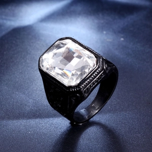 Macro shot of men's black titanium ring with a large square step-cut clear gemstone