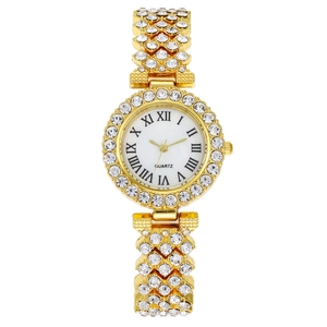 Macro shot of gold-plated women's watch featuring rhinestone encrusted case and band