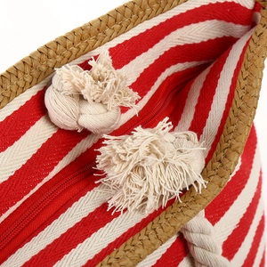 Striped canvas beach tote with woven straw trim and tassel handles in red and white