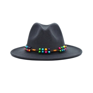 Close-up of a wide brim felt fedora hat featuring colorful beads and woven band detail