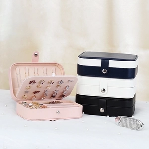 Detailed interior view of a portable faux leather jewelry box with earring and ring slots