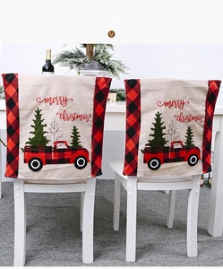 Christmas chair cover with buffalo plaid truck design on a rustic linen background