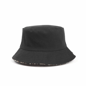 Close-up of double-sided black canvas bucket hat with leopard print lining detail