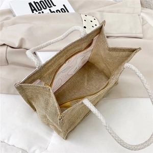 Minimalist jute tote bag with braided rope handle and cartoon print lining interior