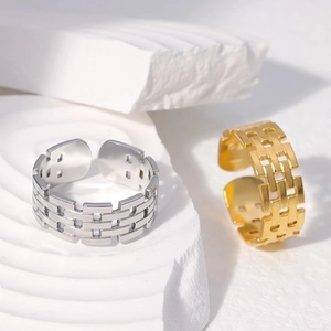 Adjustable stainless steel rings in gold and silver with textured brick pattern link design