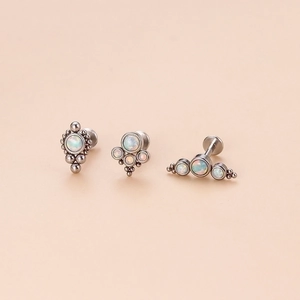 Three pieces of stylish opal lip studs with internal threading in polished steel finish