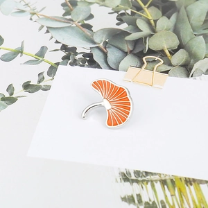 Creative orange enamel ginkgo leaf brooch with silver trim on white card display