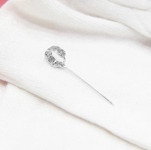 Macro shot of S925 sterling silver DIY pendant clasp with hollow pattern on white fabric