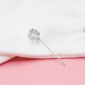 Detailed view of an S925 sterling silver hollow coin bail with a needle pin attachment