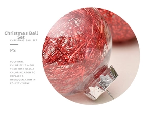 Macro detail of clear Christmas ball ornament filled with red glitter and silver cap