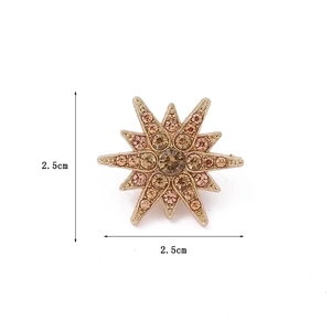 Sparkling gold starburst brooch pin with crystals for suits and shirts, 2.5cm diameter