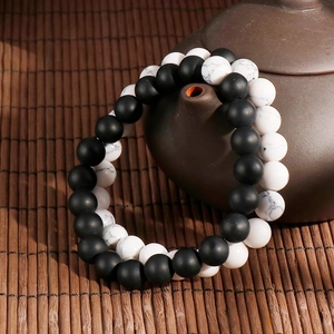 Minimalist 8mm matte black agate and white turquoise beaded bracelets on ceramic teapot